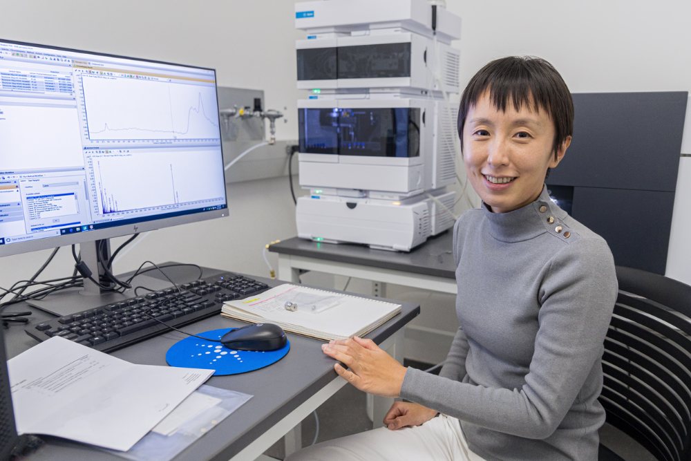 Graduate Program Chair Xuan Zhang at an instrument in her lab
